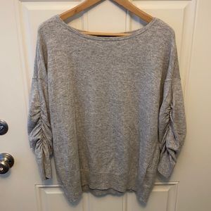 Grey sweater top with 3/4 rouched sleeves.